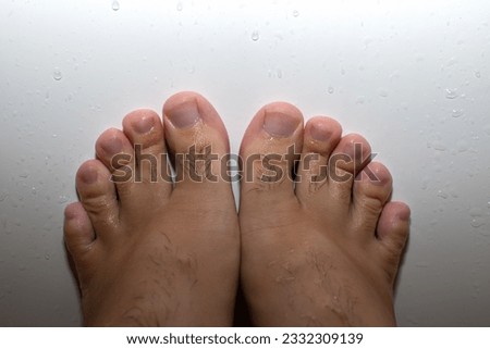 Woman with hairy toes in a bathtub