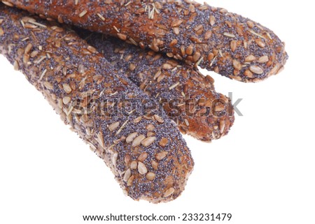 delicacy french rye bread baguette topped with sunflower and poppy seeds isolated over white background