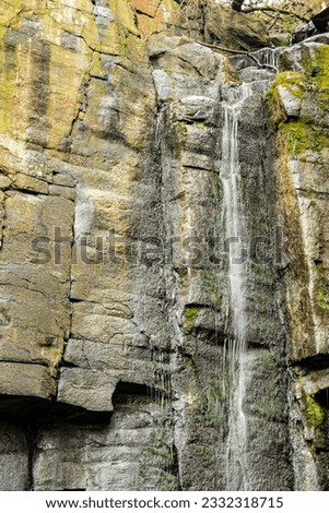 Rocks by Vanov waterfall in winter with little water