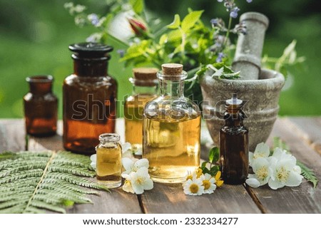 Assortment of organic essential oils, herbal extracts and medical flowers herbs In glass bottles. Alternative therapy, aromatherapy. Natural ingredients in cosmetic and medicine Royalty-Free Stock Photo #2332334277