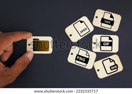 Tag wood with icons of 5 types of image files namely JPEG, PNG, GIF, TIFF and SVG. The concept of saving files in the form of an image Royalty-Free Stock Photo #2332335717