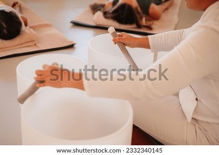 Music Therapy Session in Thailand. Sound Meditation, body healing. Seven chakras. Sunny room with 3 people meditating. Healthcare recreation process Royalty-Free Stock Photo #2332340145