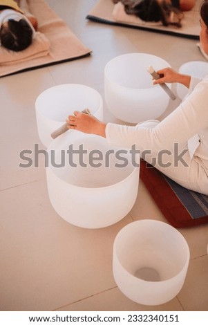 Music Therapy Session in Thailand. Sound Meditation, body healing. Seven chakras. Sunny room with 3 people meditating. Healthcare recreation process Royalty-Free Stock Photo #2332340151