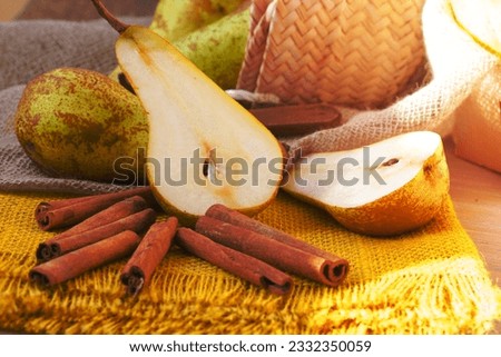 Pears on a yellow decorative sackcloth and cinnamon sticks
