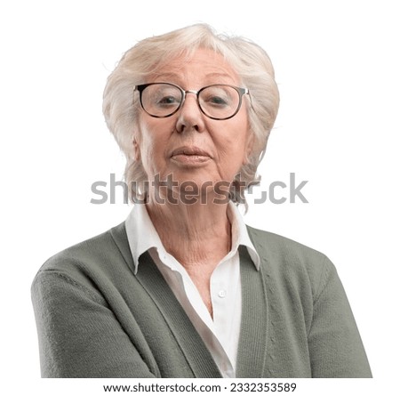 Confident senior lady looking at camera with disdain Royalty-Free Stock Photo #2332353589