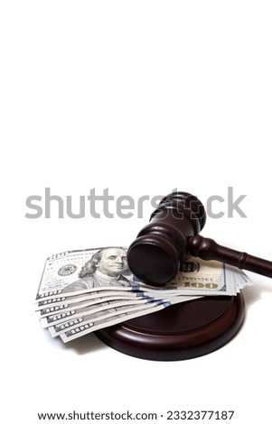 Judge's gavel and 100 american dollar banknotes on white background