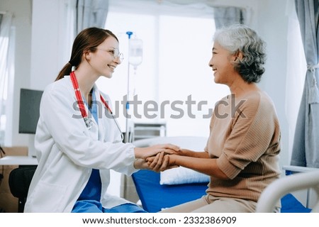 Friendly Female Head Nurse Making Rounds does Checkup on Patient Resting in Bed. She Checks tablet while Man Fully Recovering after Successful Surgery in hospital or clinic.

 Royalty-Free Stock Photo #2332386909
