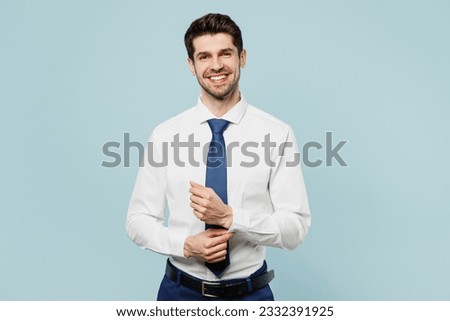 Young smiling happy successful employee business man corporate lawyer wears classic formal shirt tie work in office posing look camera isolated on plain pastel light blue background studio portrait Royalty-Free Stock Photo #2332391925