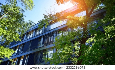 Sustainable glass office building with trees for reducing carbon dioxide. Eco-friendly building in modern city. Office with green environment. Corporate building reduce CO2. Royalty-Free Stock Photo #2332396073