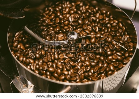 coffee beans dark oily roast aroma roasting in roastery. coffee bean roaster closeup cooling end roasting phase. cafe beverage industry