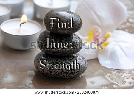 Find inner strength text engraved on black zen stones. Motivational concept. Royalty-Free Stock Photo #2332403879