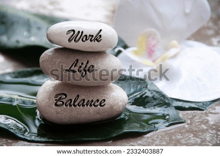 Work life balance text engraved on zen stones. Lifestyle, work and family concept