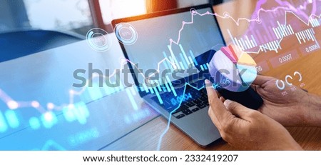 Businessman working with smartphone and laptop mock up display. Forex trading hud with pie chart and graph lines. Digital stock market dynamics and research. Concept of analytics and progress