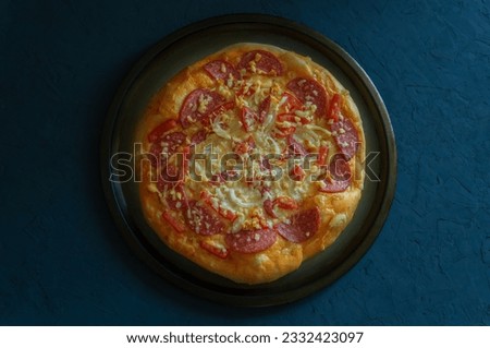 Top view of pizza on a dark background