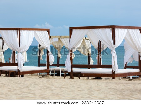 Several canopies on the beach. Focus on the main subject of the picture. Shallow depth of field.