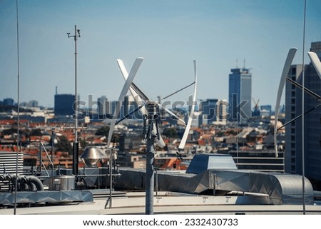 Vertical-axis wind turbine generating renewable energy on a rooftop in Berlin, Germany Royalty-Free Stock Photo #2332430733