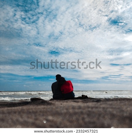 A couple in love looking at the sea
