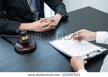 Professional Male lawyer or counselor discussing negotiation legal case with client meeting with document contract in office, law and justice, attorney, lawsuit concept. Royalty-Free Stock Photo #2332457621