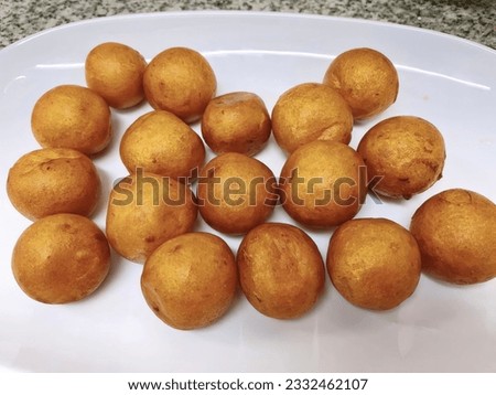 a photography of a plate of fried potatoes on a counter, arafly cooked potatoes on a white plate on a counter.