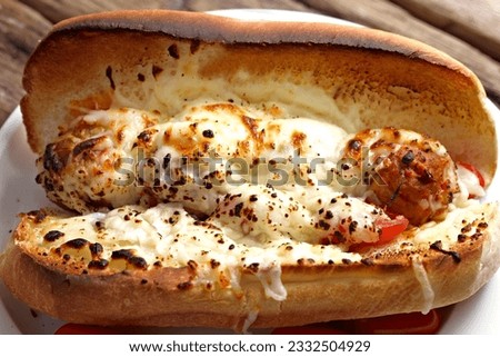 Savory Delight: Close-Up of a Meatball Sub Sandwich with Melting Cheese, A Culinary Masterpiece in 4K Resolution