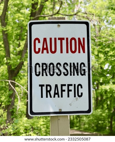 A close view of the caution crossing traffic sign.
