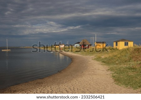 Colorful beach houses at Eriks Hale in Marstal on the Danish island of Ærø. Royalty-Free Stock Photo #2332506421
