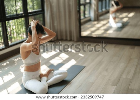Women sitting on yoga mat preparing for yoga practice