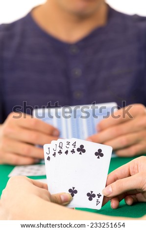 Playing cards closeup of hands holding deck cuarenta traditional Ecuadorian game selective focus