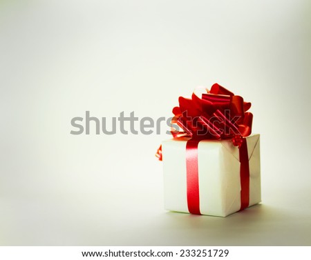 white gift paper box with red ribbon bow, isolated on white