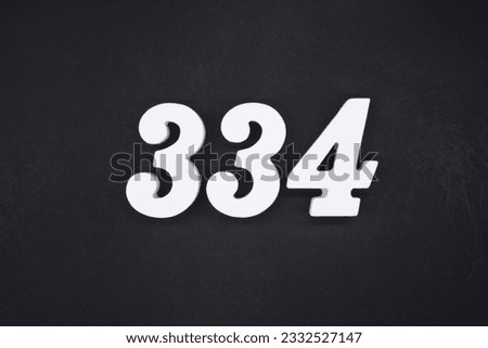 Black for the background. The number 334 is made of white painted wood.