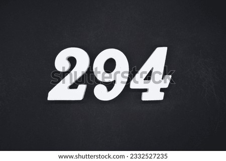 Black for the background. The number 294 is made of white painted wood.