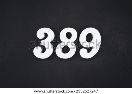 Black for the background. The number 389 is made of white painted wood.