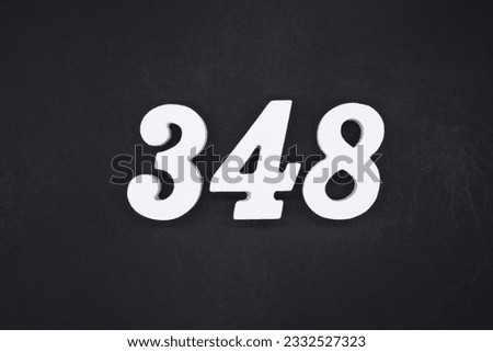 Black for the background. The number 348 is made of white painted wood.