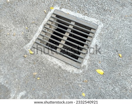 manhole safety sewer metal cover on concrete. drainage and sewage system use this square metal cover Royalty-Free Stock Photo #2332540921