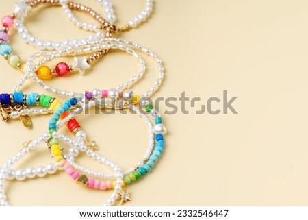 Kids handmade beaded jewelry. Necklaces and bracelets made from multicolored beads and pearls. DIY bracelet beads. Children's needlework. Creativity and hobby. Art activity for kids Royalty-Free Stock Photo #2332546447