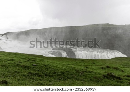 Gullfoss waterfall in Iceland, water abyss, nature landscape, cloudy sky