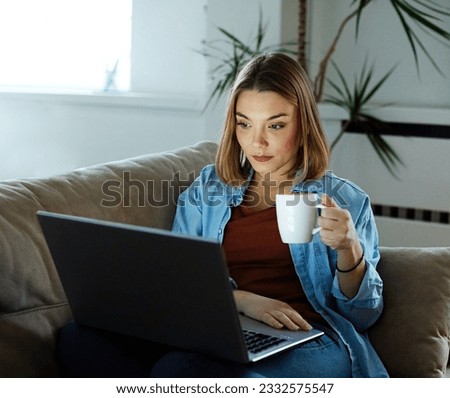 Portrait of young happy woman using laptop at night, using modern technology having fun with glowing screen in dark office or at home, startup business meeting online with businesswoman  in the office