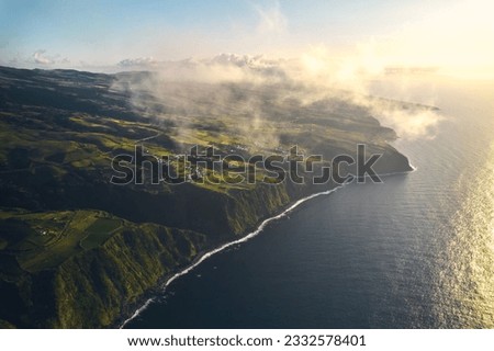 Aerial shot, drone point of view picturesque nature with green mountains, cliffs and Atlantic Ocean of Ponta Delgada Island. Azores, Portugal. Bird eye view. Travel destinations and tourism concept