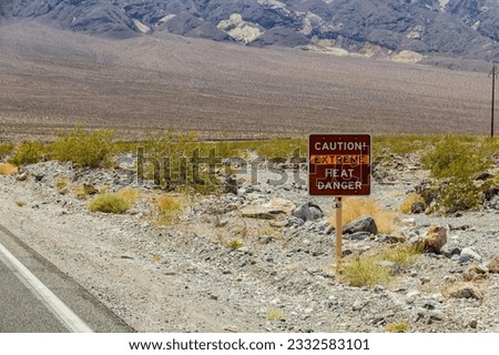 Sign Caution - Extreme Heat - Danger - indicates extreme heat and danger to life, Death Valley National Park, California, USA Royalty-Free Stock Photo #2332583101