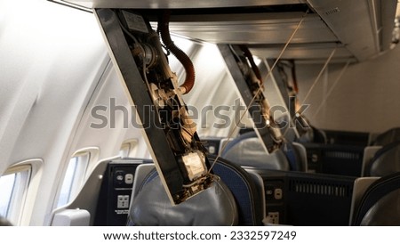 Passenger service panels dropped for maintenance in the interior of a 757 commercial Passenger airplane. Royalty-Free Stock Photo #2332597249
