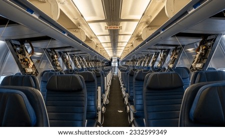 Passenger service panels dropped for maintenance in the interior of a 757 commercial Passenger airplane. Royalty-Free Stock Photo #2332599349