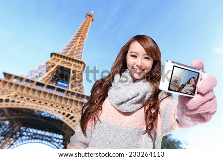 Happy travel woman take a selfie by camera with eiffel tower in Paris with blue sky