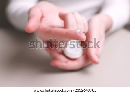 Contact lenses for vision correction in hands  Royalty-Free Stock Photo #2332649785