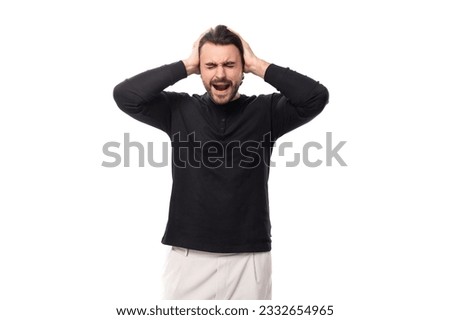 authentic brutal macho man with black hair and a beard with an earring in his ear closed his ears on an isolated white background with copy space Royalty-Free Stock Photo #2332654965