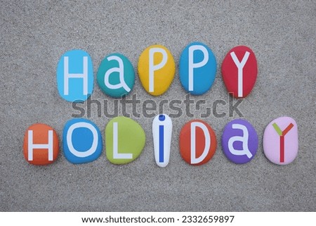 Happy Holiday, creative text composed with multi colored stone letters over beach sand