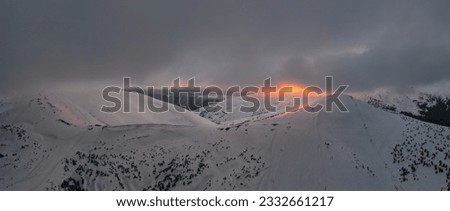 Sun rays illuminate the mountain valley. Location place ski resort Dragobrat, Carpathian, Ukraine, Europe. Splendid picture of winter journey. Great nature wallpapers. Aerial drone picture.