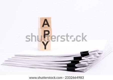 wooden cubes with text APY on white table