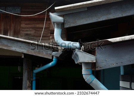 Galvanized rain gutter, drainage with pvc pipes in front of the house