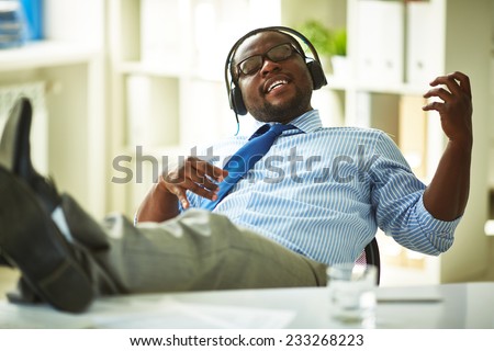 Businessman sitting in headphones in office