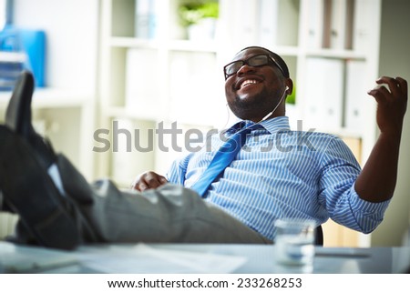 Office worker listening to music at workplace